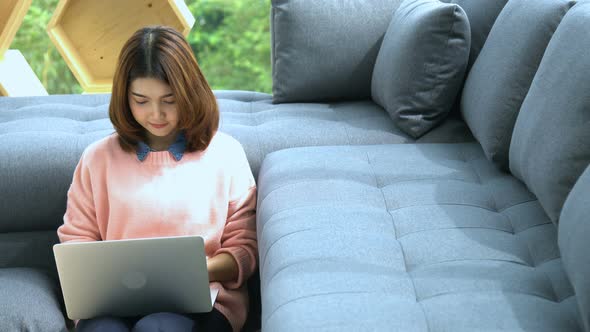 beautiful smart asian woman relax time with laptop shop online in living room house background alt