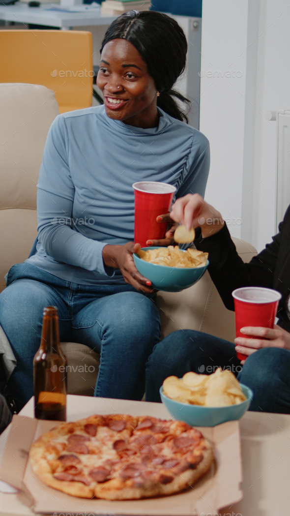 People enjoying drinks and snacks after work for leisure Stock Photo by  DC_Studio