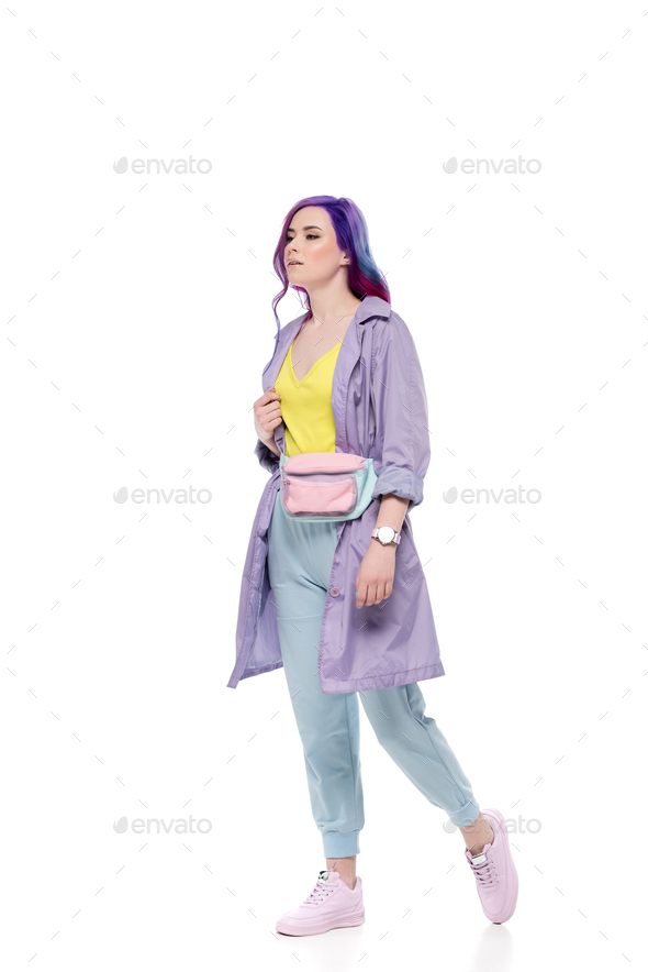 stylish young woman in purple trench coat with waist pack isolated on white