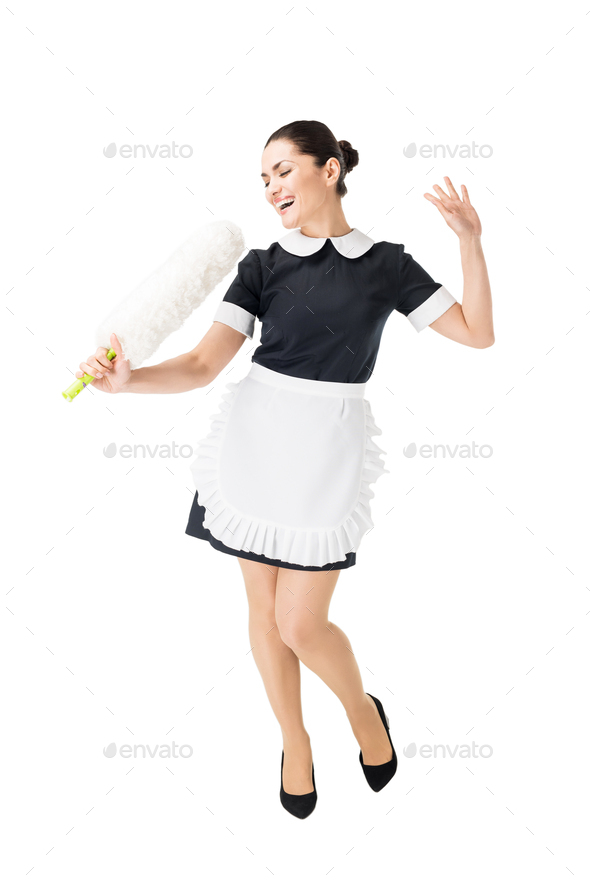 Professional maid in uniform having fun and singing in duster isolated on white