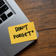 Don&#39;t forget message concept written post it on laptop keyboard	 - PhotoDune Item for Sale