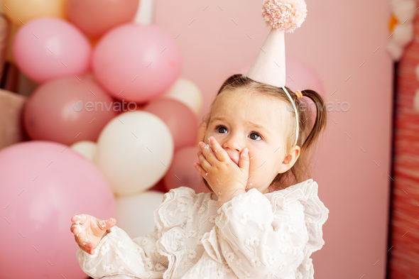 Premium Photo  Cute smiling baby girl in pink dress with her first  birthday cake