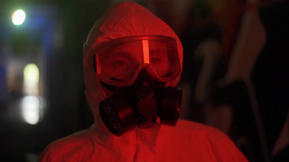 Portrait of a Man in Protective Costume Suit Walk By Dark Smoke Hall alt