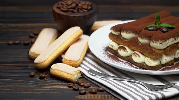 Classic Tiramisu Dessert and Savoiardi Cookies on Ceramic Plate on Wooden Background alt