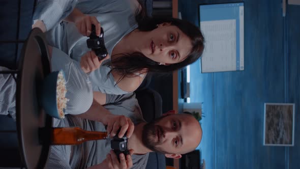 Vertical Video Focused Determined Couple Playing Video Game Late Night alt