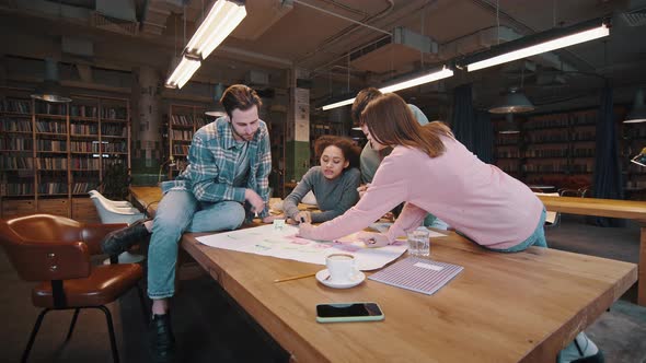 Young Multiracial Colleagues Teamworking on Startup Using Markers Colored Sticks alt