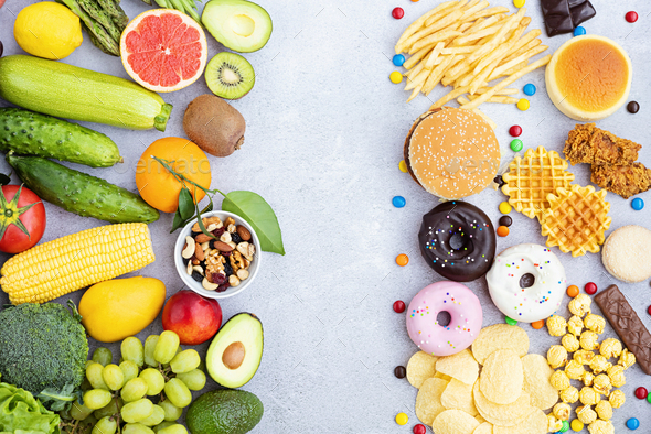Flat lay of Healthy and unhealthy food from fruits and vegetables vs fast food, sweets and pastry on