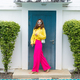 Stylish fit fashion women in bright pink wide leg pants and yellow
