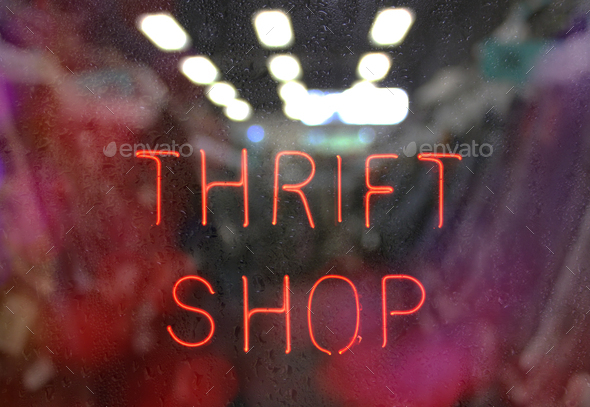 Vintage Neon Thrift Shop Sign in Wet Rainy Window