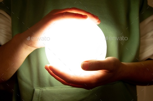 Moon lamp turn on with white background hold by two hands of a girl