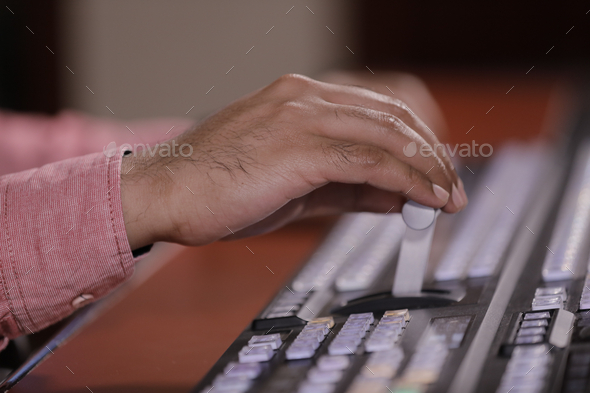 Hand operating video production switcher, television, audio visual, av, buttons