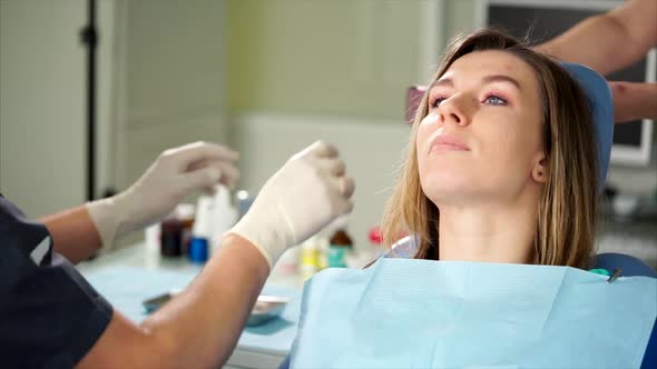 Dentist Giving Female Patient Protective Orange Goggles alt