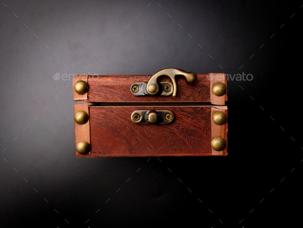 A locked mysterious wooden chest is on a black background. - Stock Photo - Images
