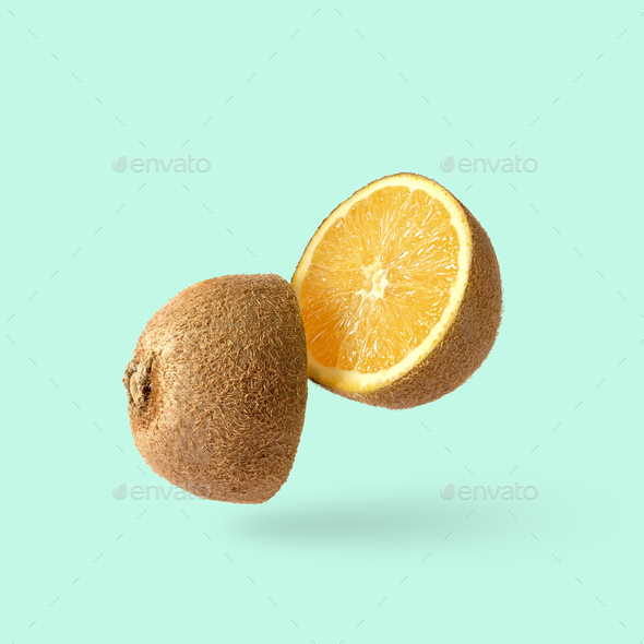 Cut kiwi fruit and inside an orange. Joke minimal pop art surprise fun poster. - Stock Photo - Images