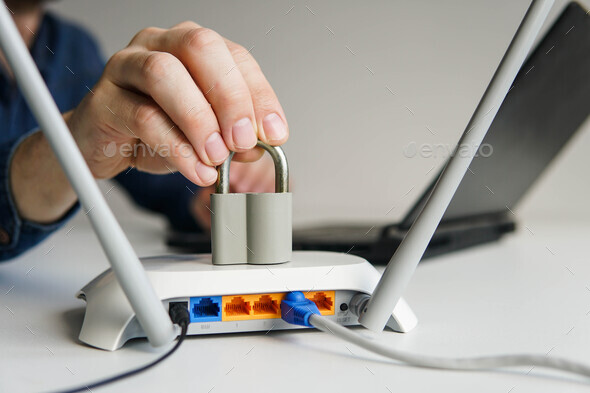 High speed wi-fi router with lock. Man using laptop on the background. - Stock Photo - Images