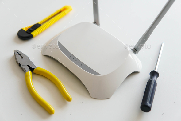 Repairing tools with a wireless wifi router on the table. - Stock Photo - Images