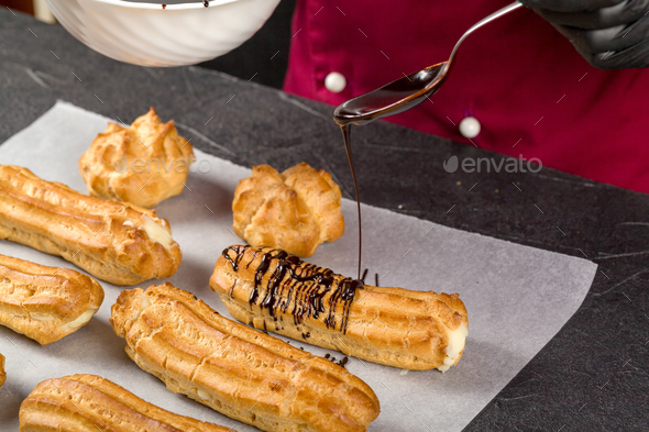Chocolate is used by the pastry chef to decorate ready-made eclairs