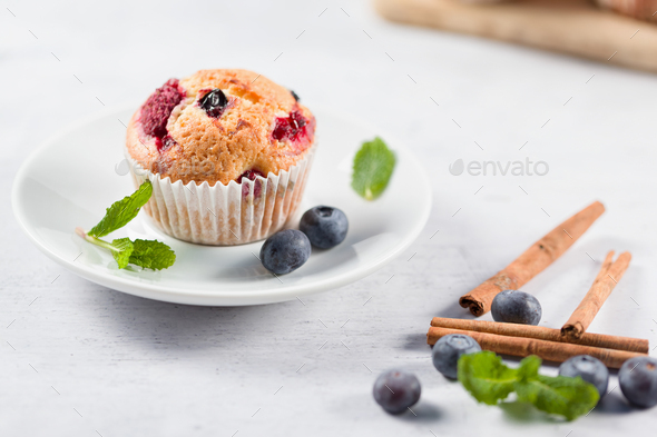 Freshly baked muffins with fresh berries - Stock Photo - Images