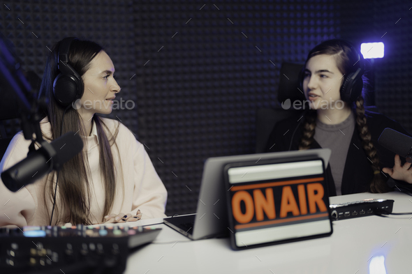 Women speaking during radio program in studio