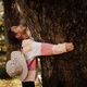 Smiling asian little girl is hug the tree with love and care in the forest. - PhotoDune Item for Sale