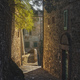 Campiglia Marittima sunlit street in old town. Tuscany, Italy - PhotoDune Item for Sale