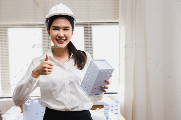 Engineer woman holding building model for architecture work