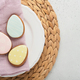 Easter table setting. Easter dinner with multicolored easter eggs. Elegance pastel and pink tablesca - PhotoDune Item for Sale