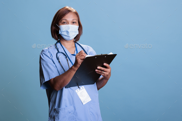 Nurse wearing medical face mask to prevent infection with coronavirus
