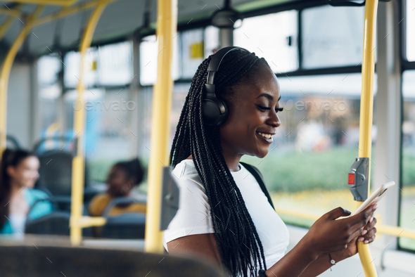 African american woman riding in a bus and using a smartphone Stock ...