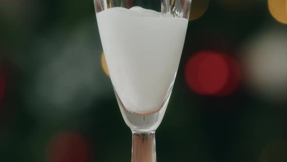 Pour the Champagne into the glass, bubbles alt