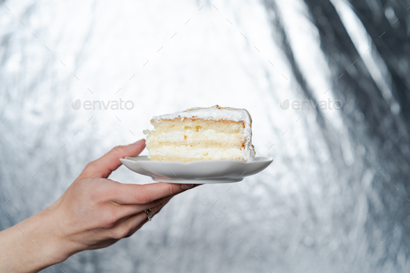 Holding plate with Slice of lemon meringue pie  - Stock Photo - Images