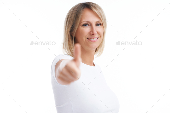 Picture of blonde woman over back isolated background showing ok - Stock Photo - Images