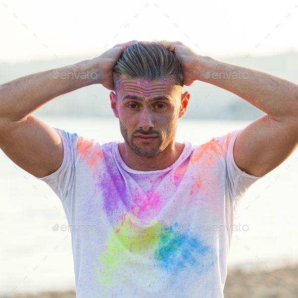 Man jumping with colored powder - Stock Photo - Images