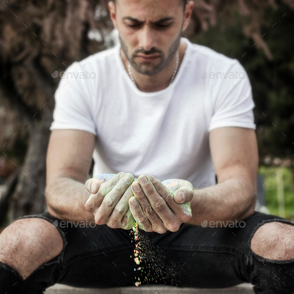 Man with colored powder in the hands. - Stock Photo - Images