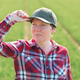 Portrait of female farmer in cultivated wheat seedling field - PhotoDune Item for Sale