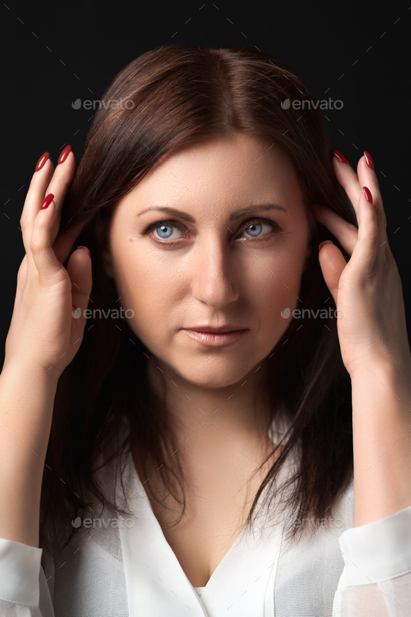 Portrait thoughtful woman worrying about personal problems, raised hands near head, looking away