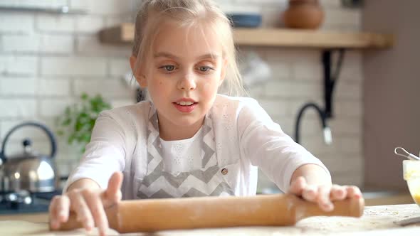 Smiling Little Kid Girl Kneading Dough with Rollin Pin