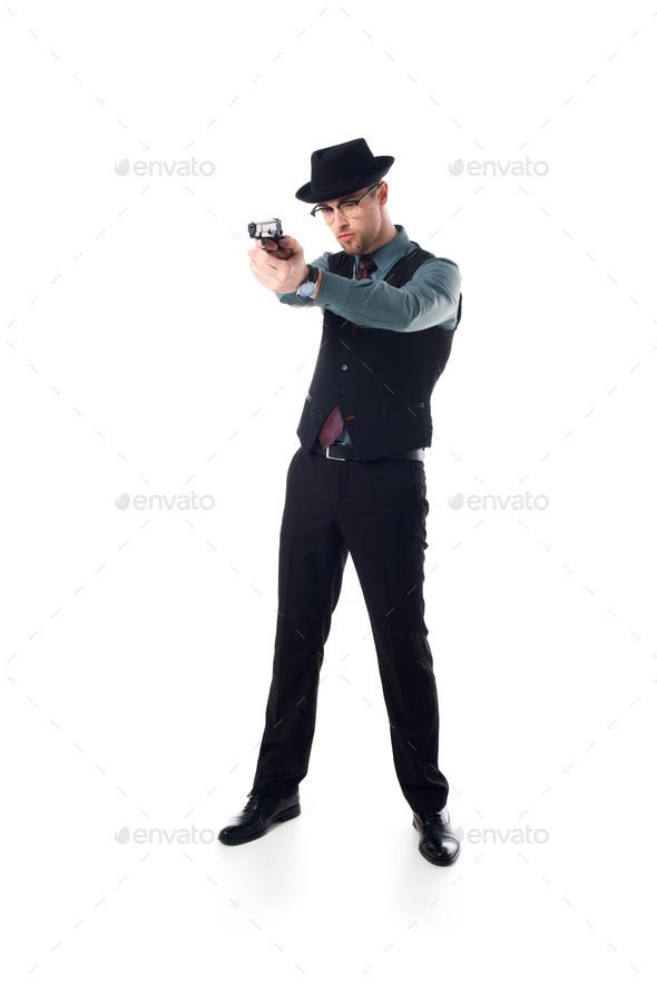 stylish spy agent in hat and eyeglasses with gun isolated on white