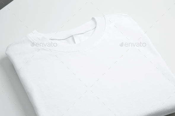 Basic folded white t-shirt. Mock up for branding t-shirt. Copy space