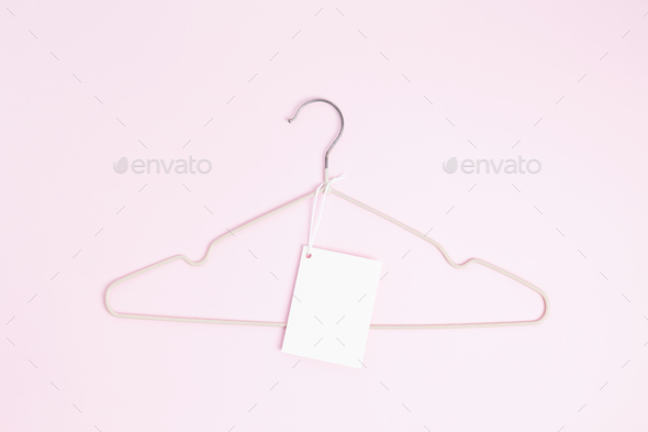 Creative flat lay hanger with white paper label. Clothing tag, label blank mockup template
