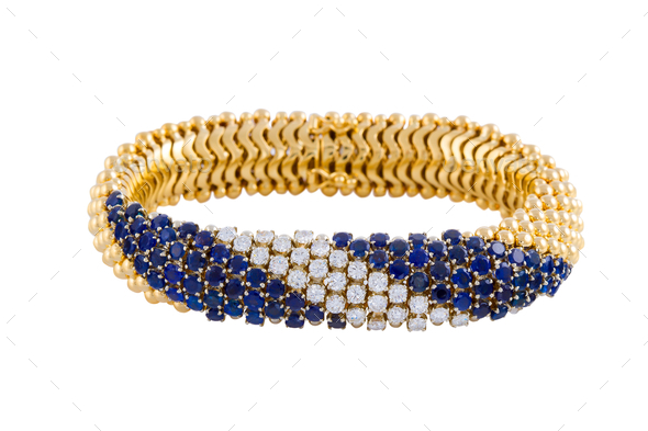 Female gold bracelet with diamonds and sapphire isolated on a white background
