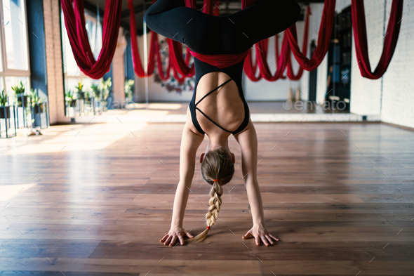 Selective focus of aerial yoga swings on background of an flexible