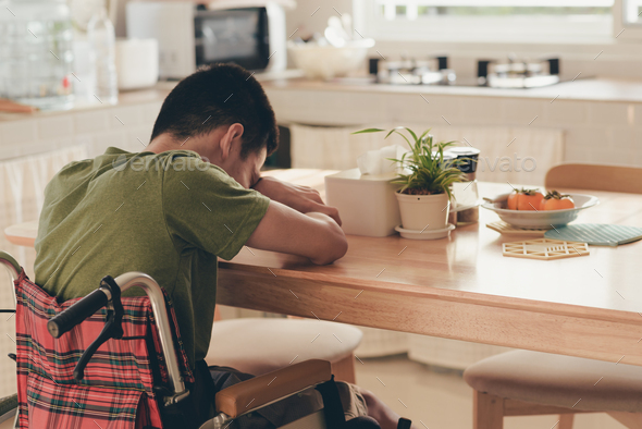 Young man with disability on wheelchair with emotional, Alone in the house. - Stock Photo - Images