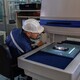 An engineer using optical micrometer quality checking micro part and close up look - PhotoDune Item for Sale