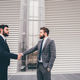 Young bearded professional businessman shake hand with partner - PhotoDune Item for Sale