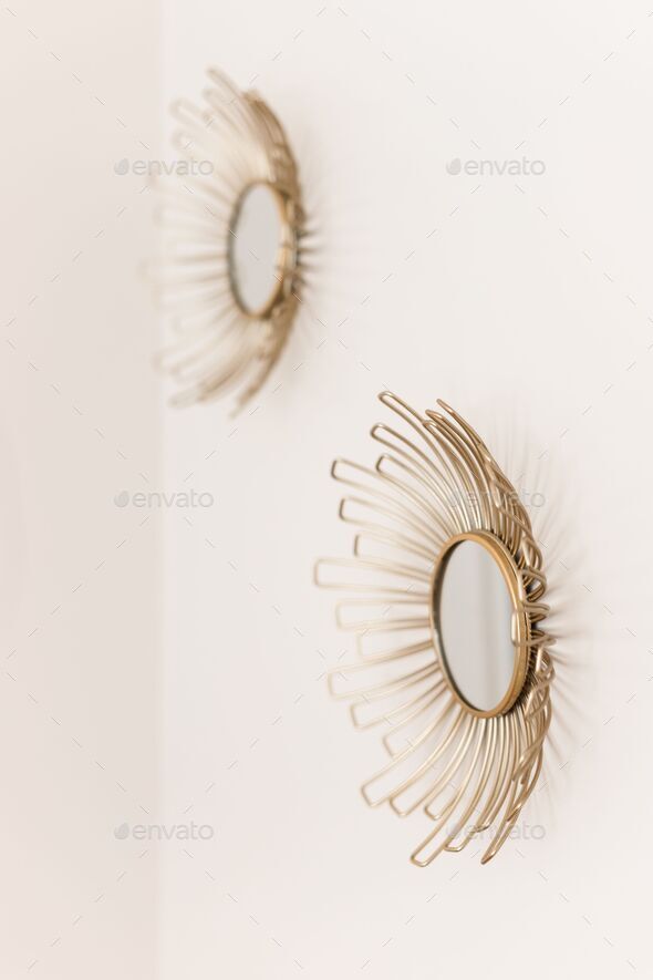 White wall with two beautiful round gold sun mirrors Stock Photo by