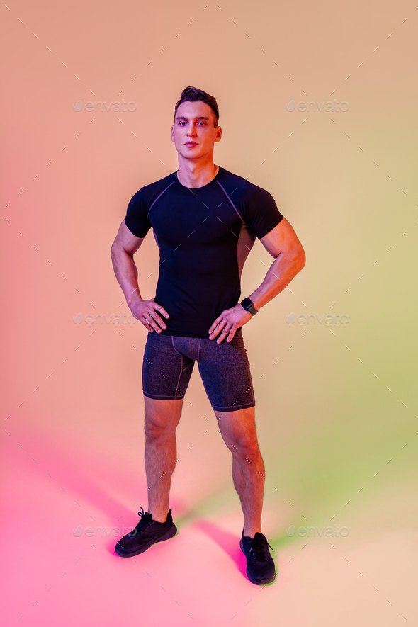 Athletic man with fit muscular body training in studio Stock Photo