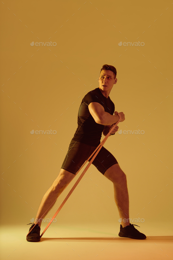 Athletic man with fit muscular body training in studio - Stock Photo - Images