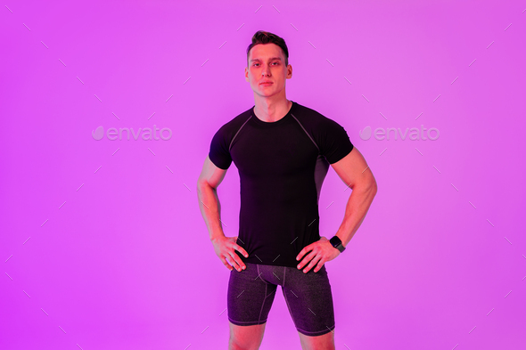 Athletic man with fit muscular body training in studio - Stock Photo - Images