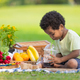 A curly hair children with soft drinks during picnic in the park. - PhotoDune Item for Sale